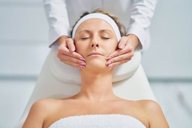 istock Young nice woman having face massage in spa 1466980066
