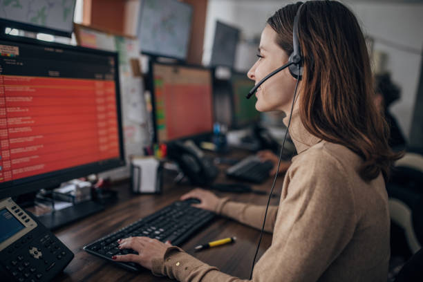 Taxi service operator One woman, female taxi service operator with headset working in call center. dispatcher stock pictures, royalty-free photos & images