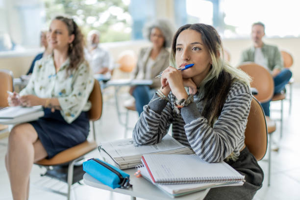 istock Young female student paying attention in class at college 1466981948
