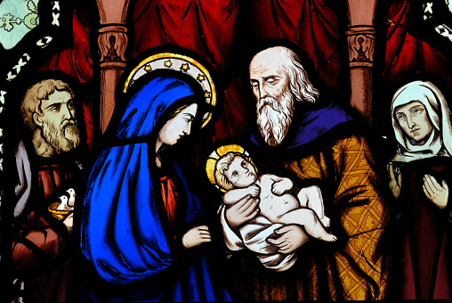 Antique stained glass window, depicting a biblical scene with Mary and Baby Jesus