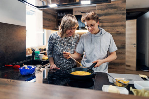 Mother and son preparing breakfast together