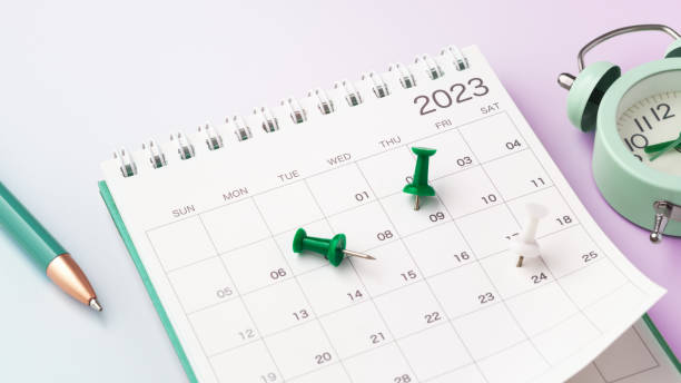 istock Scheduling and planning concept, calendar with green pin and clock on gradient background 1466986626