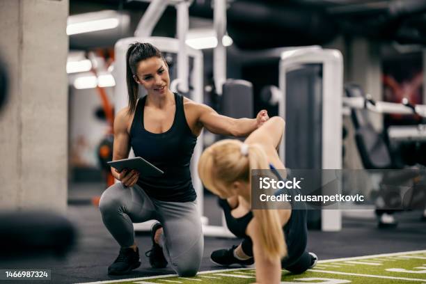 A Female Trainer Is Helping Sportswoman With Workouts In A Gym Stock Photo - Download Image Now