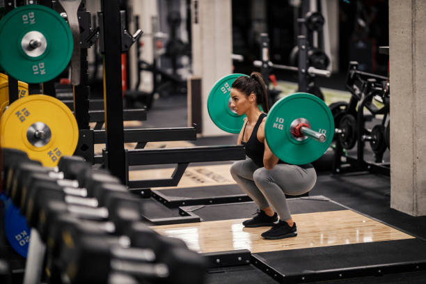istock A strong female bodybuilder is lifting heavy barbell in a gym. 1466989111