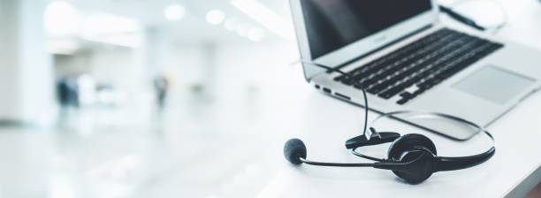 istock Headset and customer support equipment at call center ready for actively service . Corporate business help desk and telephone assistance concept . 1466993131