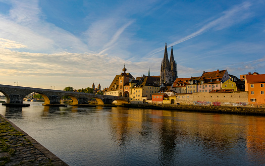 Trip to Regensburg. Early morning along the Danube river. View to the cathedral St. Peter and the old stone bridge.