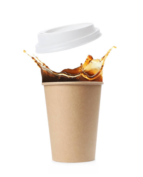 istock Takeaway paper cup with splashing coffee and plastic lid on white background 1466993519