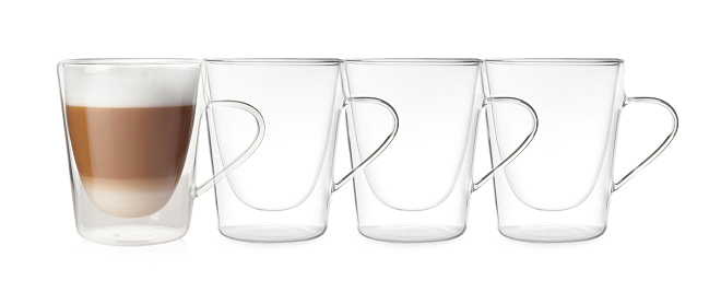 Empty glass cups and one with aromatic coffee on white background. Banner design