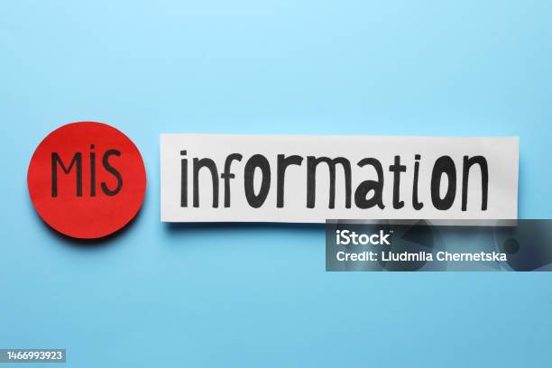Word Misinformation Made With Paper Pieces On Light Blue Background Flat Lay Stock Photo - Download Image Now