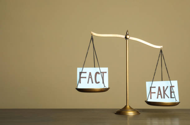 istock Scales with words FACT and FAKE on wooden table, space for text 1466994055