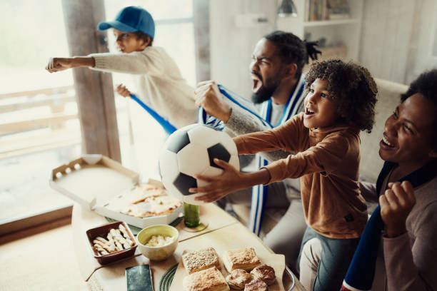 istock Cheering for favorite soccer team at home! 1466995400
