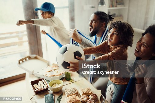 istock Cheering for favorite soccer team at home! 1466995400