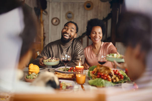 istock Happy black parents talking to their kids during lunch at dining table. 1466996369