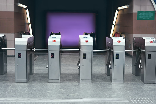 Many modern turnstiles outdoors. Fare collection system