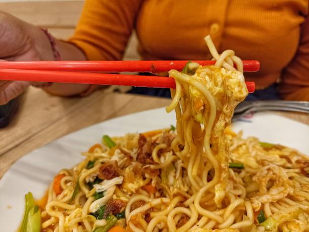 istock fried noodles on red chopsticks 1466998132