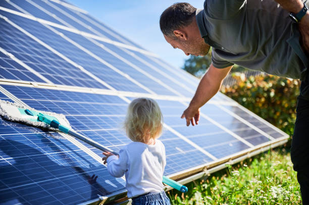 istock Man showing his small child the solar panels during warm day 1466998830
