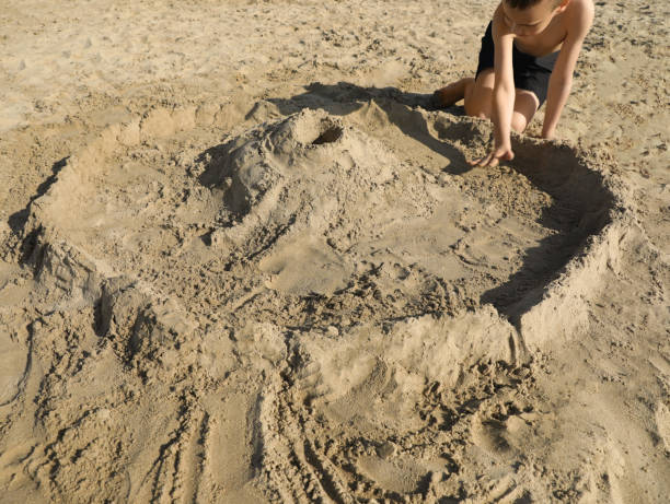 istock Little boy playing with sand on sunny day 1466998946