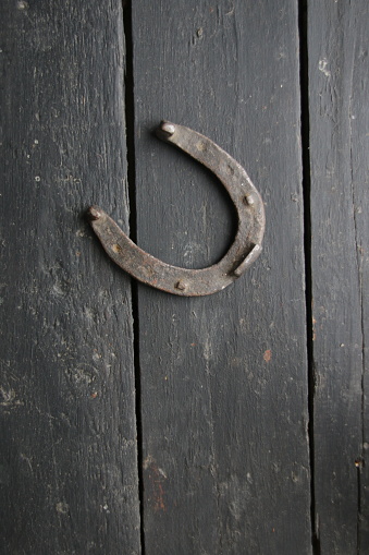 An old horseshoe on a vintage table. Retro style.
