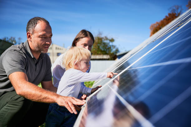 Enthusiastic father showing potential of alternative energy. stock photo
