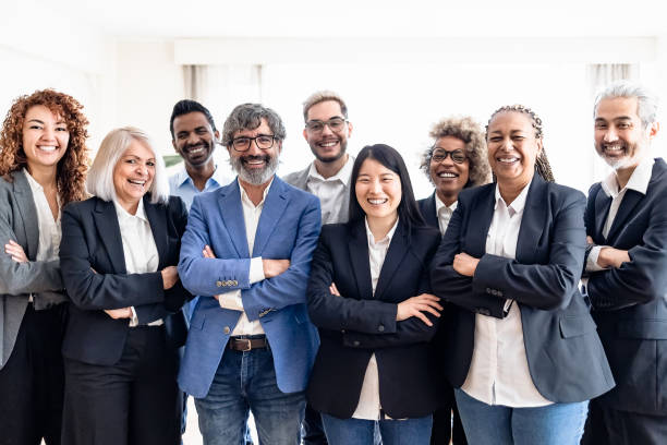 Business team of multiracial people standing in front of camera during meeting work stock photo