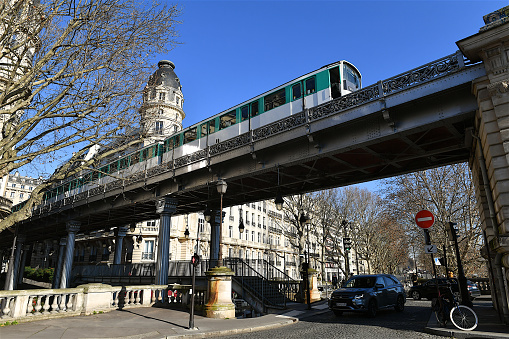 Paris, France-02 07 2023: Aerial metro train passing over the Bir-Hakeim railway bridge above the Seine river in Paris, France.
