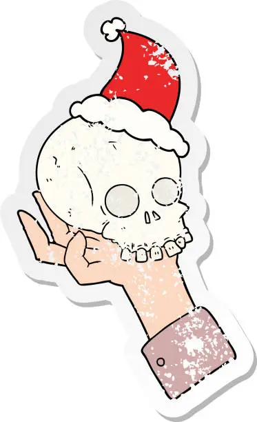 Vector illustration of hand drawn distressed sticker cartoon of a hand holding skull wearing santa hat