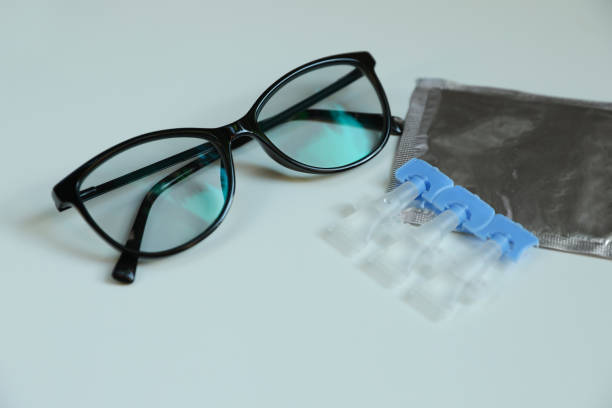istock Single dose eye drops and glasses on white table, closeup 1467010655