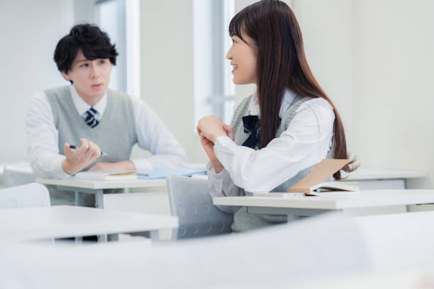 istock A high school student talking amiably with her classmates in a classroom 1467010863
