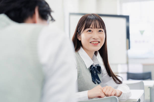 istock A high school student talking amiably with her classmates in a classroom 1467010888