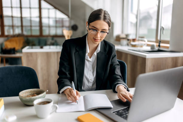 istock Young beautiful businesswoman working from her kitchen 1467012093