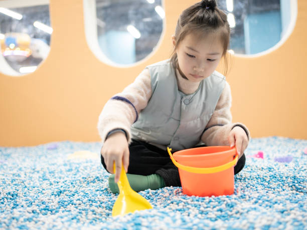 istock girl playing with colored sand 1467012469
