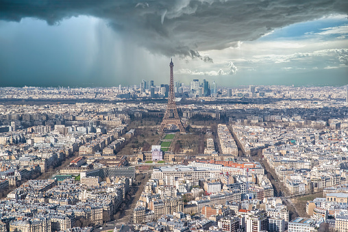 Paris, aerial view of the Eiffel Tower in a storm, with the Defense towers in background