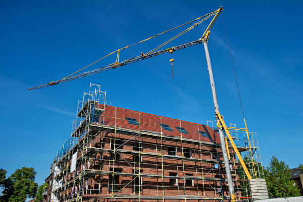 istock Scaffolding and a construction crane near a high-rise brick house under construction in Germany. 1467018162