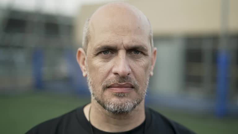 Middle age football referee looking at camera before amateur championship game