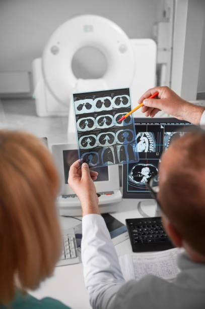 istock Doctor and nurse sitting at computer, looking at MRI results. 1467026032