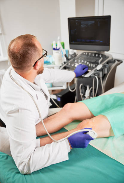 istock Doctor making ultrasound diagnostics, patient lying on coach. 1467026112