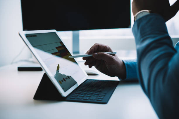 istock Faceless smart male entrepreneur working on tablet using stylus 1467026518