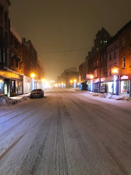 istock Snow covered city street at night. 1467028533