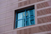 Window with a blue frame on the brown wall of the business center.
