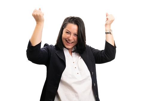 Cheerful adult businesswoman smiling celebrating victory success with hands fists gesture wearing formal office clothing isolated on white background