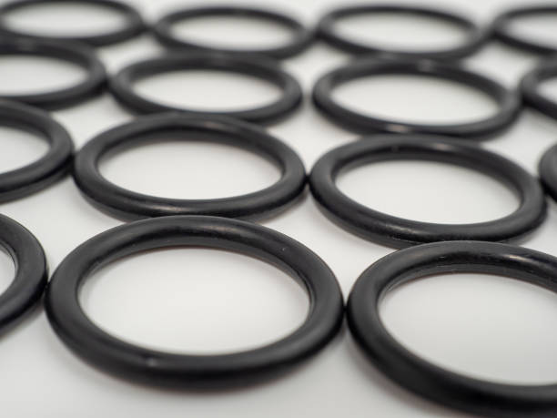 Hydraulic and pneumatic o-rings in black in different sizes on a white background. Rubber gaskets for plumbing.