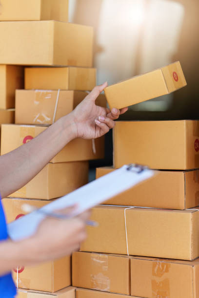 istock Asian courier with parcel and delivery logistic concept. Delivery man with checking list on clipboard 1467032729
