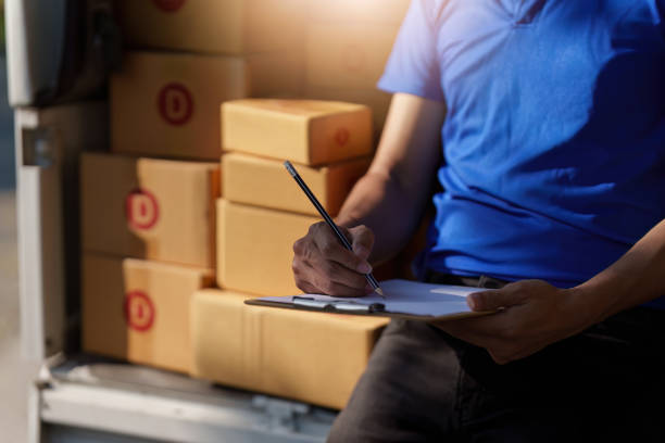 istock Asian courier with parcel and delivery logistic concept. Delivery man with checking list on clipboard 1467034469