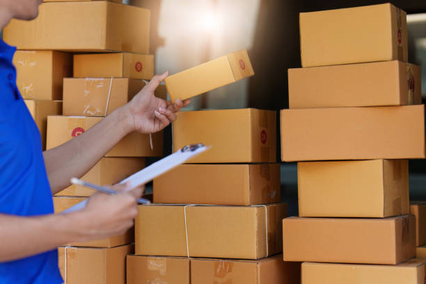 istock Asian courier with parcel and delivery logistic concept. Delivery man with checking list on clipboard 1467034526
