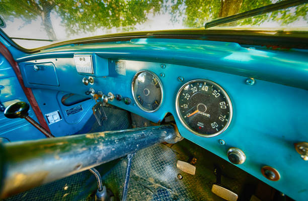 istock An old, blue International lorry parked under an oak tree with mottled sunlight. 1467035385