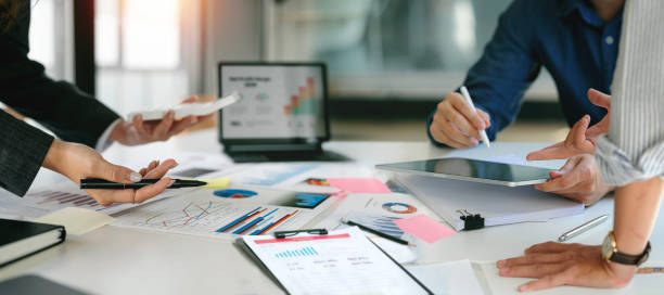 istock diverse coworkers working together in boardroom, brainstorming, discussing and analyzing and planning business strategy. 1467035710
