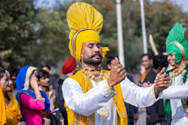 Male artist performing bhangra dance stock photo