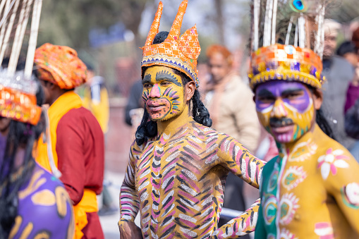 Bikaner, Rajasthan, India - January 2023: Camel festival, Portrait of young artist with painted face of animal while participating in the parade of annual camel festival in Bikaner. Selective focus.