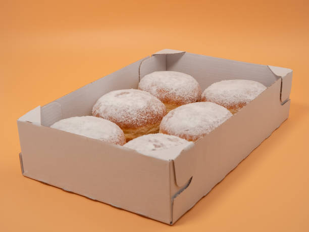 istock Freshly baked and dusted with powdered sugar German donuts. 1467038339