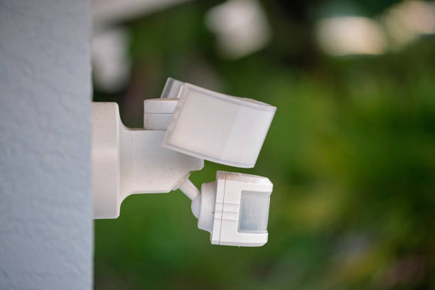 istock Motion sensor with light detector mounted on exterior wall of private house as part of security system 1467038516